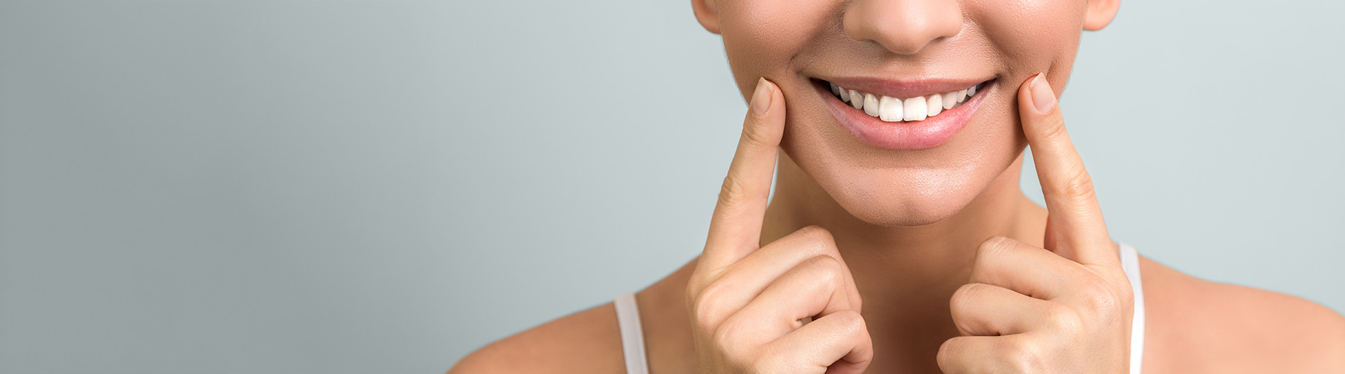 The image displays a woman with a neutral expression looking directly at the camera, showcasing her facial features and skin texture.