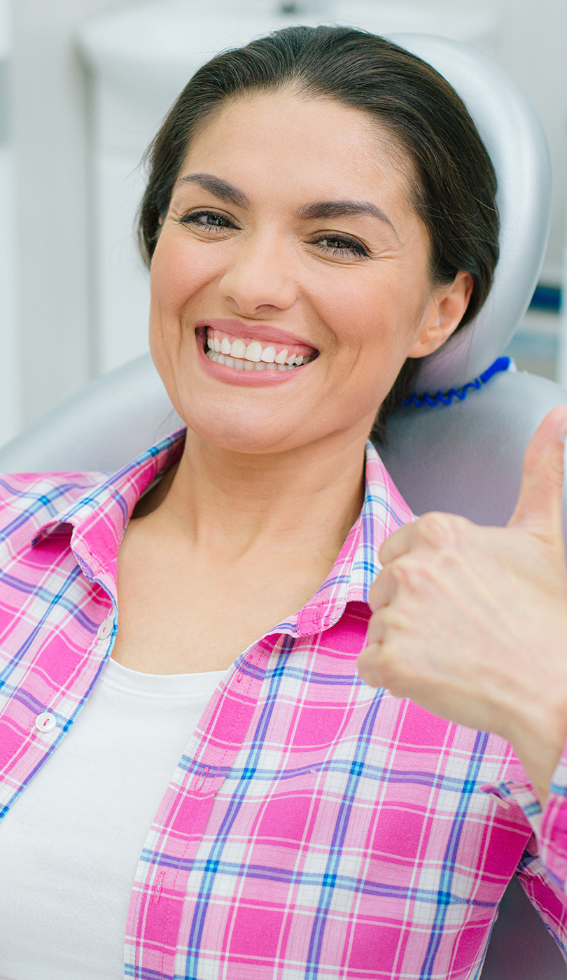 The image shows a modern dental or medical office interior with a dental chair, equipment, and a clean, professional environment.